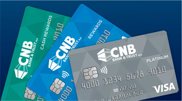 Three CNB debit cards spread on a table